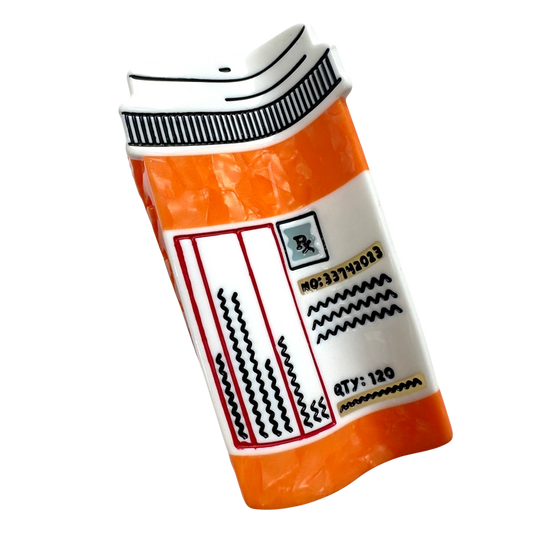 Front of prescription bottle hair claw against a blank background.