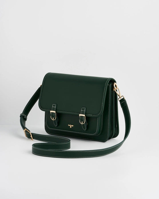 Front of dark green purse with long strap at an angle against a white background.