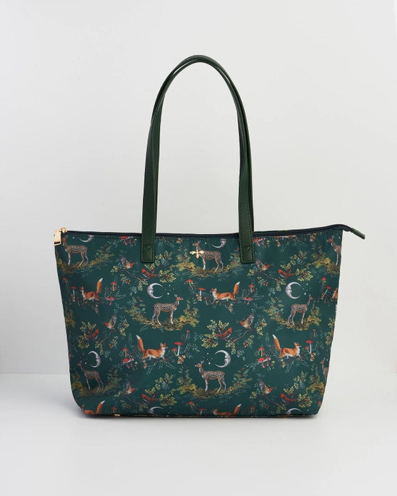 Front of tote bag with green handles against a white background.