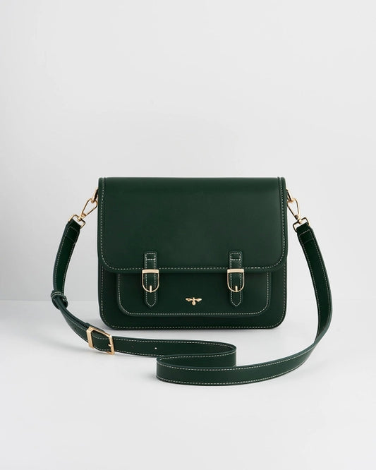 Front of darker green purse with gold buckles and long strap against a white background.