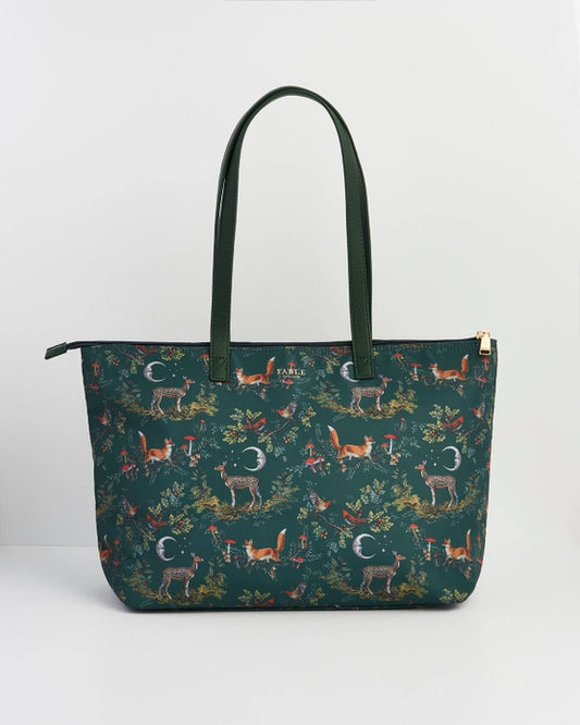 Front of tote bag with green handle against a white background.