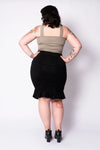 Model facing away showcasing the back of the skirt against a white background