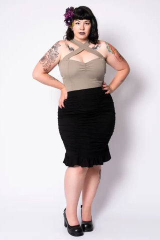 Model facing front with hands on hip showcasing the skirt against a white background