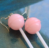 Light pink earrings on blue background