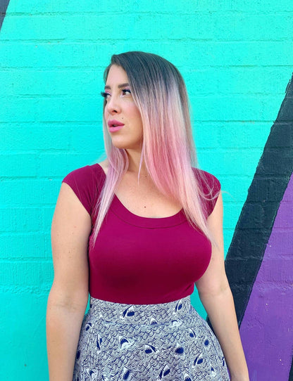 Close up of model wearing top against a colorful background