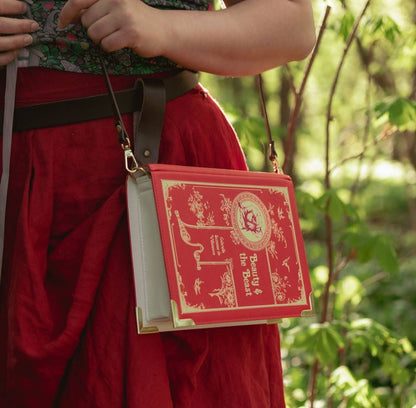 Close up of model wearing purse against a forestry background