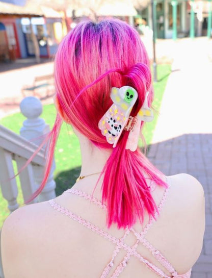 UFO Hair Claw modeled in pink hair against a light background.