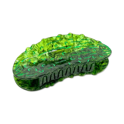 Green pickle hair claw showing the teeth of the hair claw against a white background.