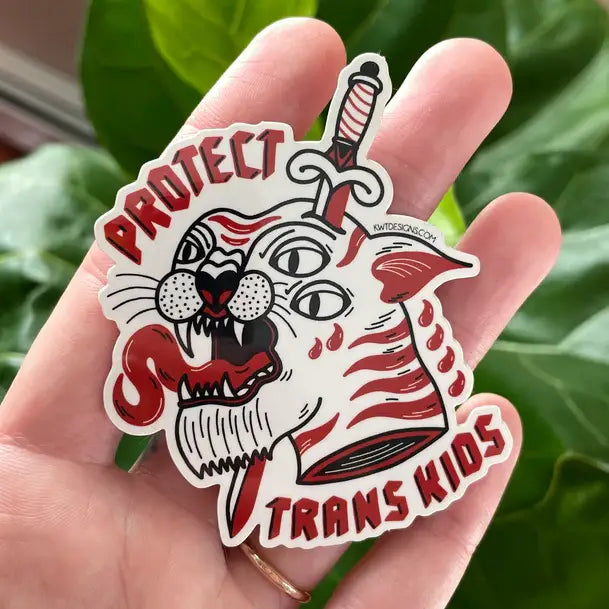 "Protect Trans Kids" phrase surrounding a tigers head with a dagger in it's head.