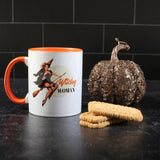 Mug with a sequin pumpkin and a stack of cookies against a black background