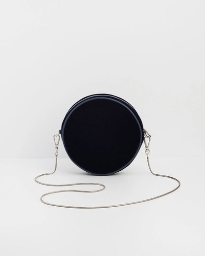 Back of purse with chain against a white background.