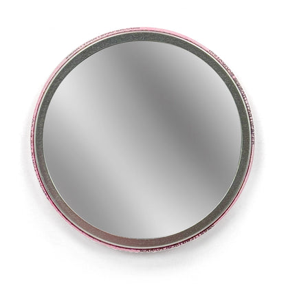 Round mirror against a white background.