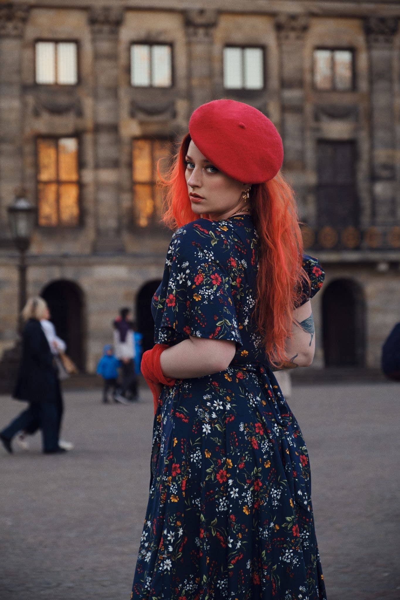 Redheaded model facing away from camera while looking back