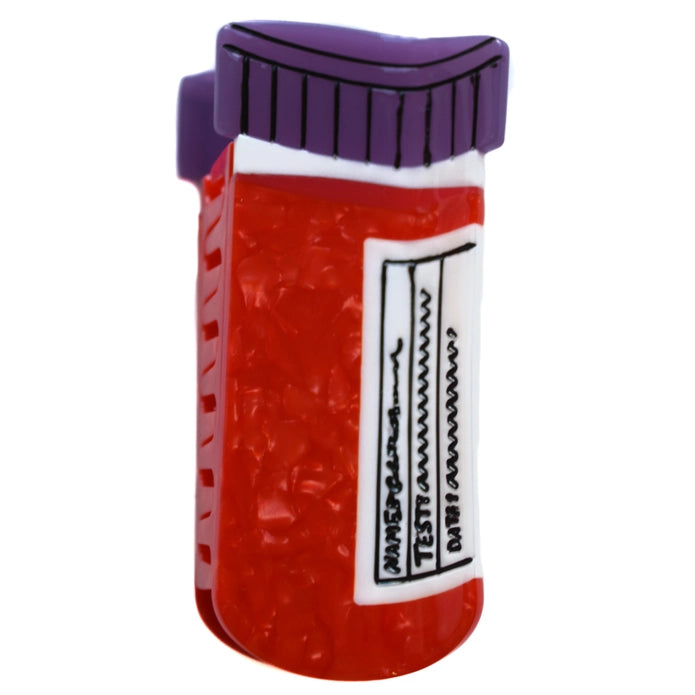 Red blood vial hair claw with purple cap against a white background.