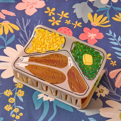 TV dinner hair claw laying flat against a floral background.