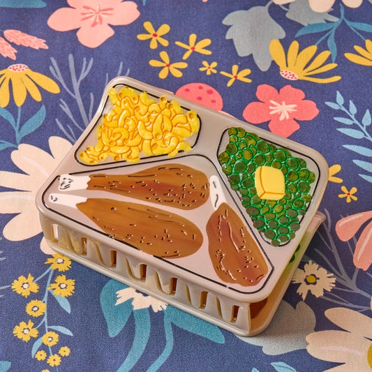 TV dinner hair claw laying flat against a floral background.