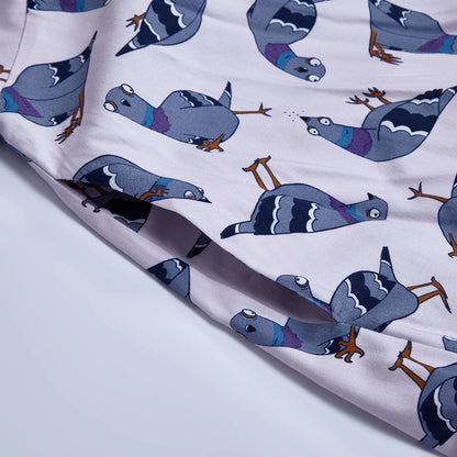 Close up of pigeons on the dress against a white background.