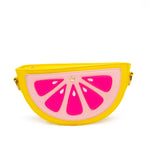 Purse is shown against a white background. Purse is a half of a grapefruit. Purse is yellow with a light pink center, and dark pink accents. Purse is show straight on