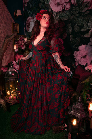 Model wearing dress against floral background