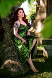 Photo shows a white female presenting model wearing the Medusa Dress. Model is sitting against a tree with one leg up
