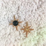 This photo shows the back of the pin, which is a gold color and a black rubber backing
