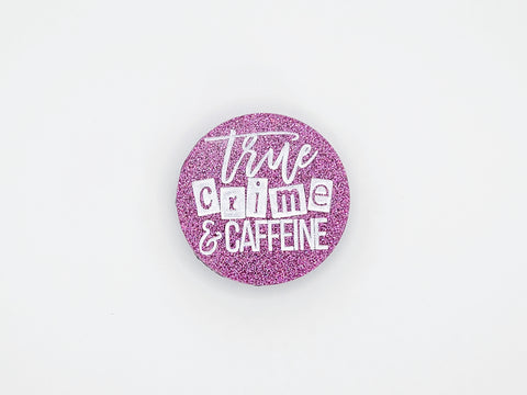 Round holographic pink phone grip with the phrase "true crime and caffeine" in white lettering