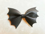 Close up of bow against a plain background