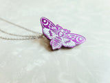 Purple glittery resin death moth with white detailing. Has 3 silver chains