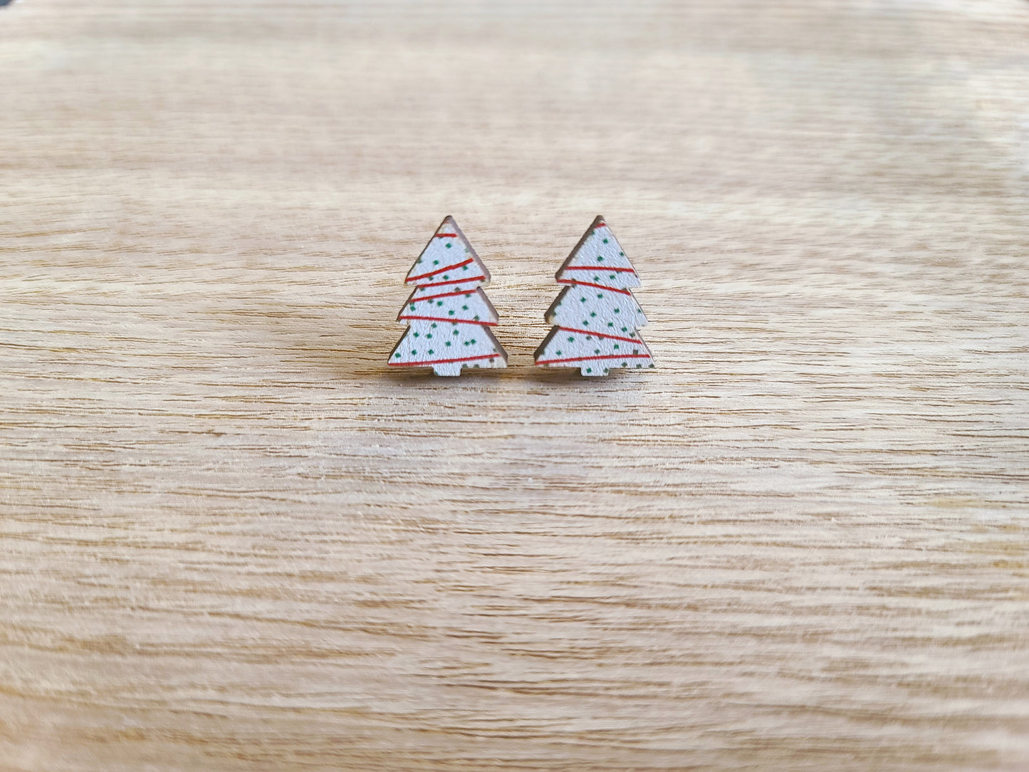 Earrings against wood background