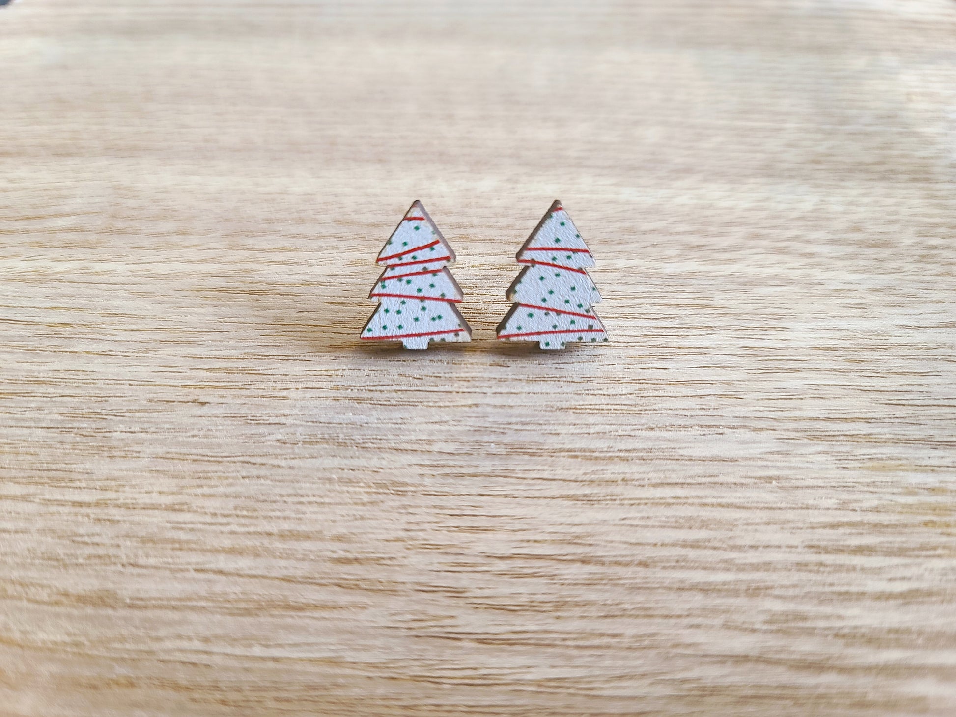 Earrings against wood background