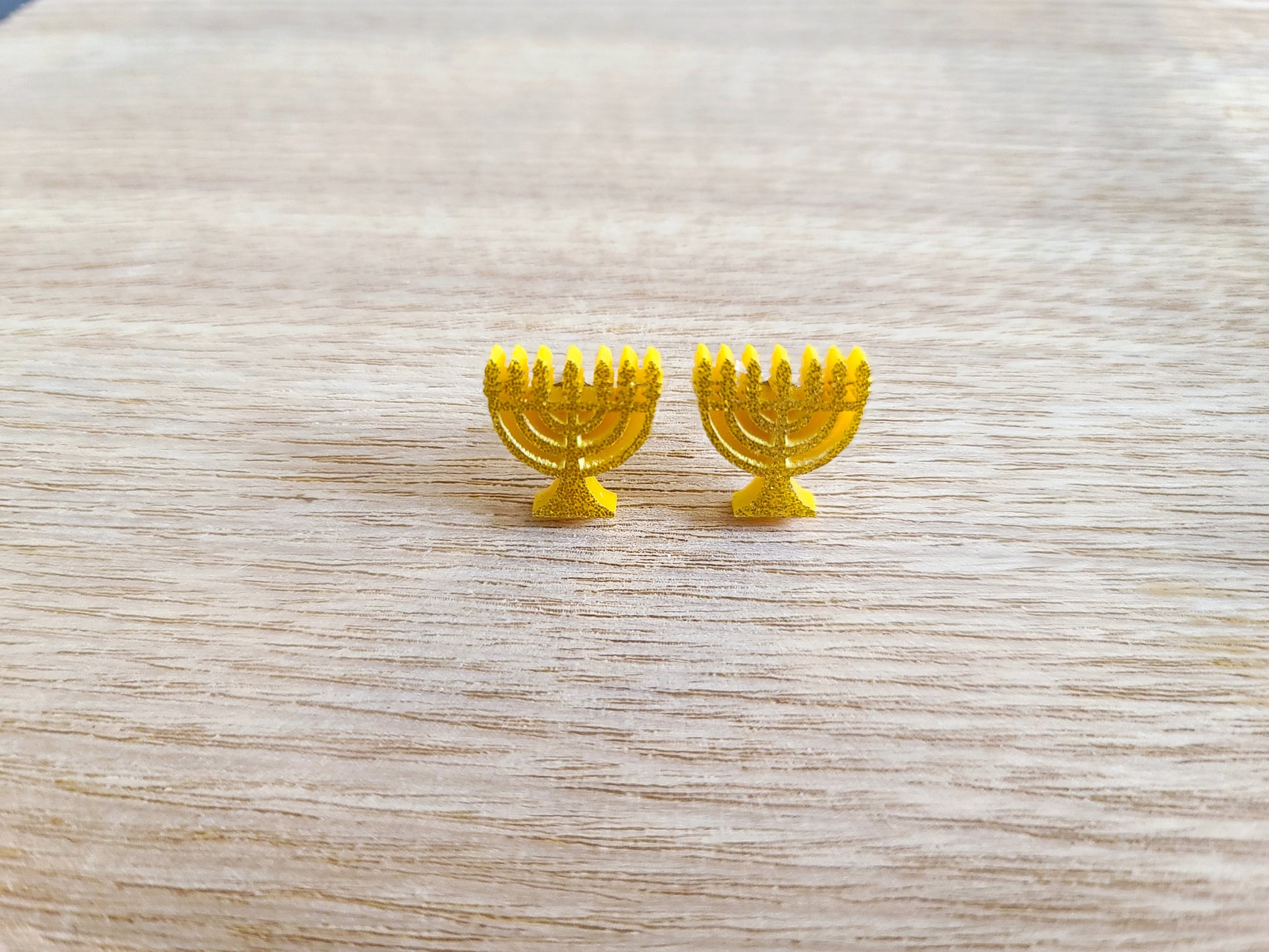 Earrings against wood background