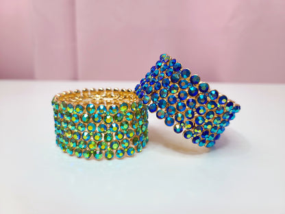 The 2 colors of bracelets styled in a pose