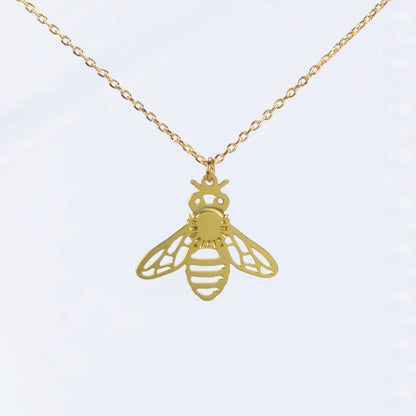 This photo shows an upclose look at the necklace. Necklace is gold in color, and the bee is a single gold colored bee