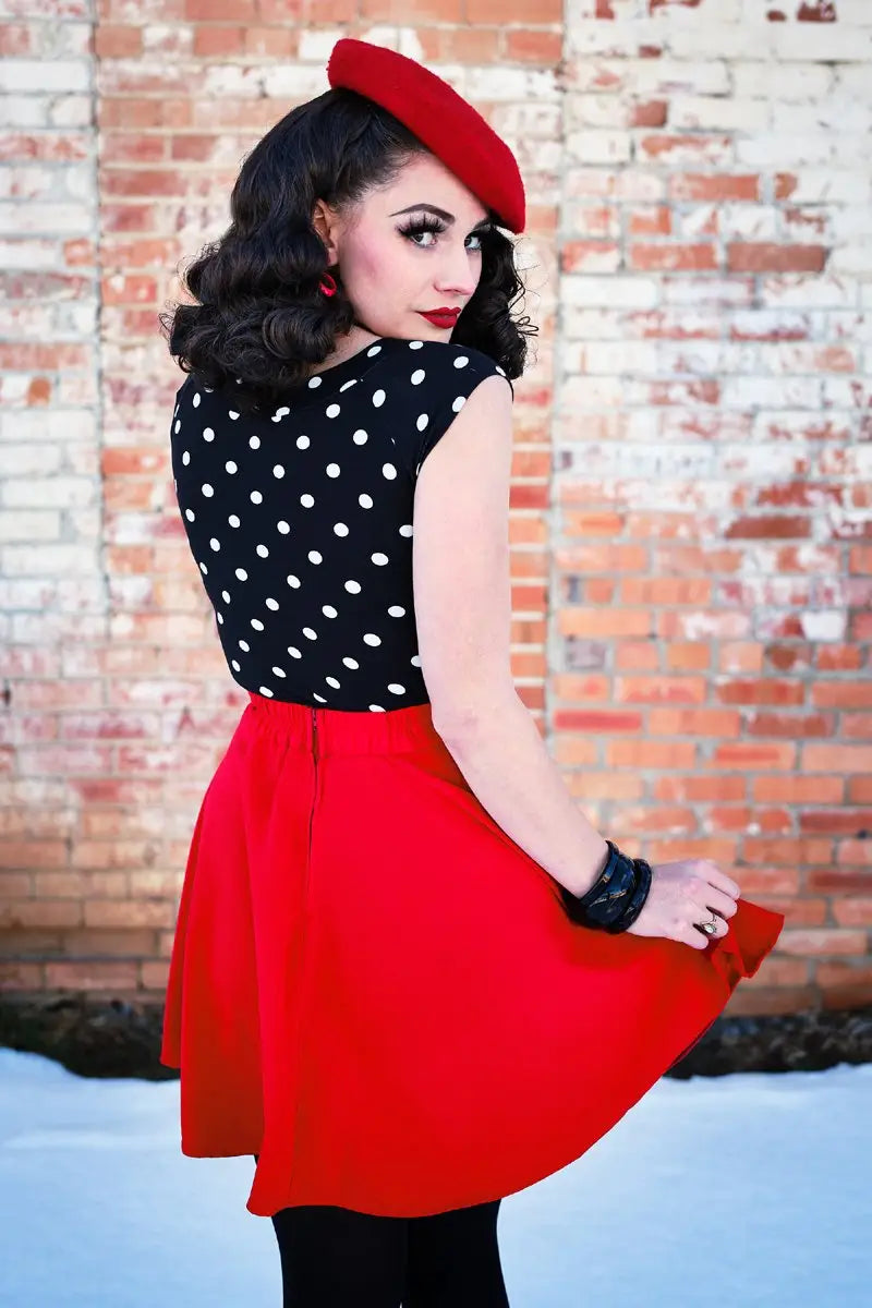 Model showing back of skirt against a brick background