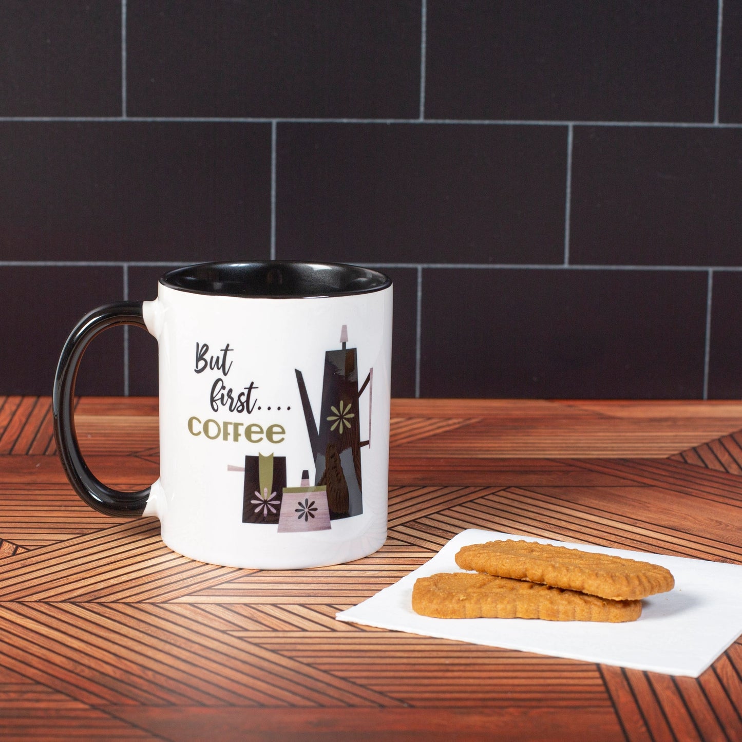 Mug against a black background with 2 cookies to the right of it