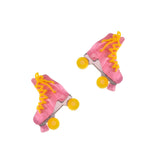 This photo shows the earrings upclose. Earrings are a marble-y pink roller skate with yellow laces, and wheels