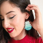 Model wearing one earring with hand at ear