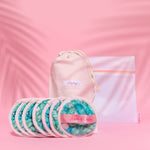 Makeup erasers and bag against a pink background