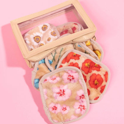 Makeup erasers spilling out of box against a pink background