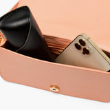 This photo shows the inside of the purse with an iphone and a glasses case to showcase the capacity of thepurse