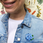 Brooch shown worn on a denim jacket