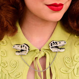 Clips shown on a collar of a yellow cardigan