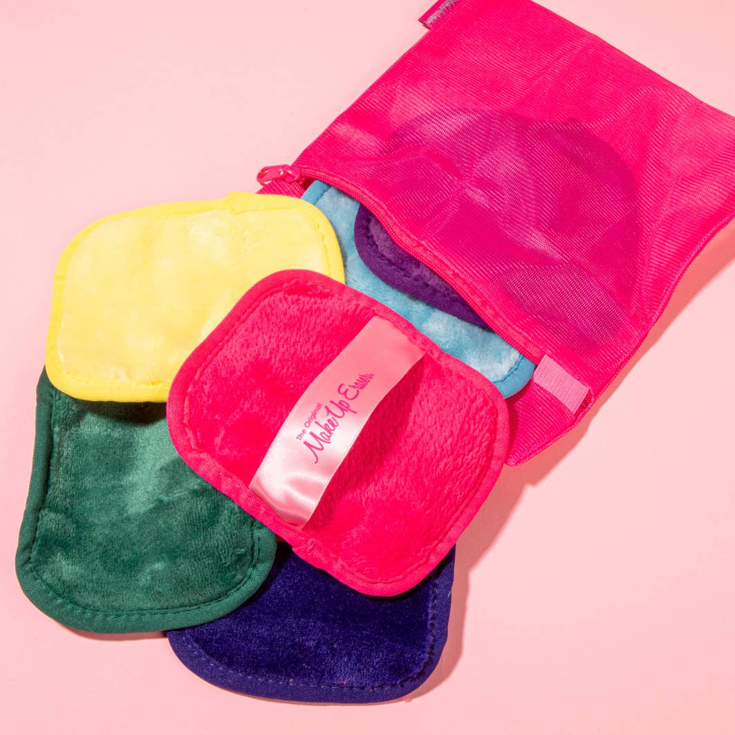 Makeup erasers in a pile against a pink background