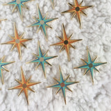 This photo showcases both colors the pin comes in, and it has multiple pins all against a white carpet like background