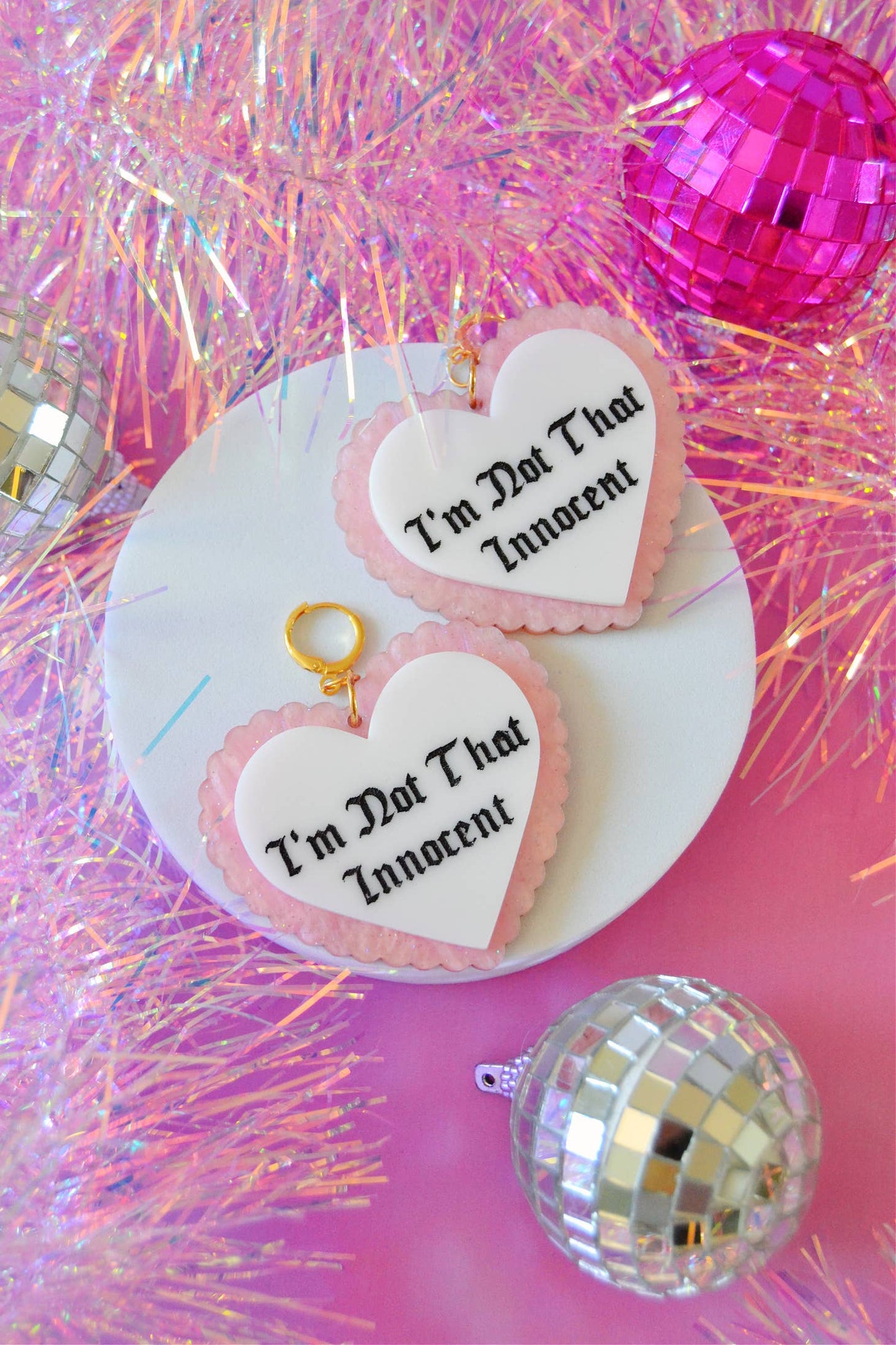 Earrings against pink background