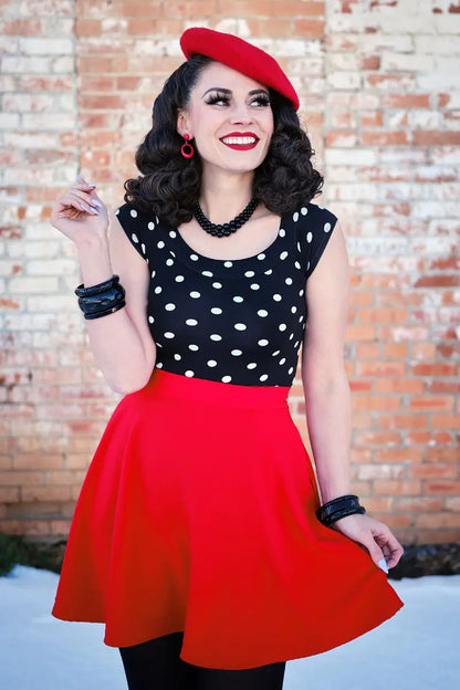 Model wearing skirt against a brick background