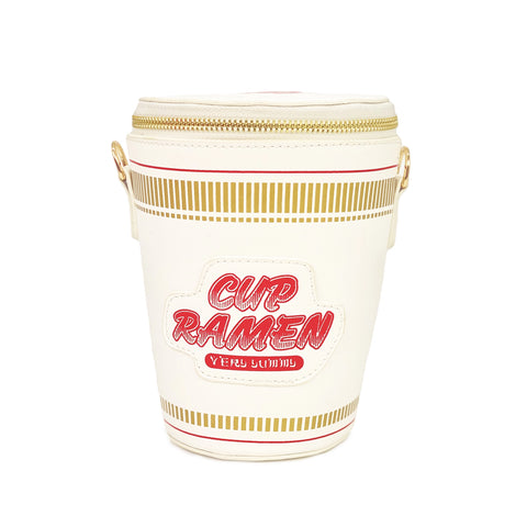 Photo shows purse from the front. Purse is a white noodle cup with yellow and red accents. Says "Cup Ramen" in large red and white lettering and "very yummy" in smaller lettering underneath