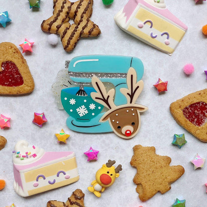 Brooch surrounded by mini cakes and desserts