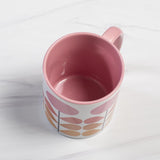 1959s mid century modern pink flowers on a white background coffee mug. Has ombre orange to yellow leaves. Inside of mug is pink, and the handle is also pink