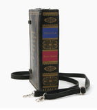Photo shows the binded book side of the purse with the book information on matte black vinyl. DRACULA in gold letters on a blue background, and Bram Stocker in gold letters on a red background. Surrounded by gold detailing